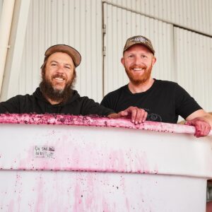 Hadyn and Darcy processing grapes to make wine 