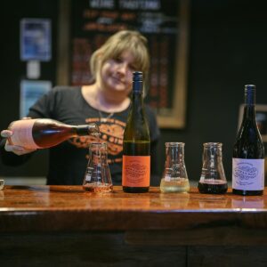 Lucy Black pouring tasting wines at the Black & Ginger Wine Shed 