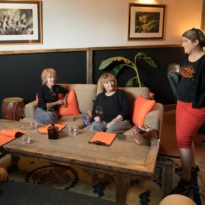 Customers enjoying a wine tasting experience at the wine shed